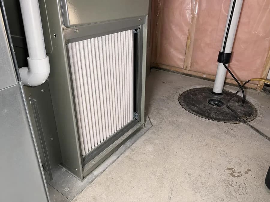 Furnace filter and sump pump area in a residential utility room